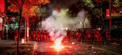 Law enforcement officers take position as a fire burns nearby during an anti-government protest demanding snap elections, in Belgrade, Serbia, June 28, 2025. REUTERS/Marko Djurica