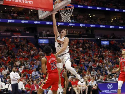 Denver Nuggets forward Vlatko Cancar (31) attempts a layup in front of New Orleans Pelicans guard Trey Murphy III (25) in the second half of an Emirates NBA Cup basketball game in New Orleans, Friday, Nov. 15, 2024. (AP Photo/Tyler Kaufman)
