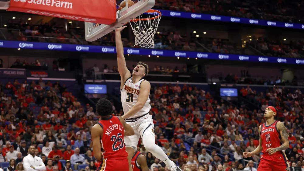 Denver Nuggets forward Vlatko Cancar (31) attempts a layup in front of New Orleans Pelicans guard Trey Murphy III (25) in the second half of an Emirates NBA Cup basketball game in New Orleans, Friday, Nov. 15, 2024. (AP Photo/Tyler Kaufman)