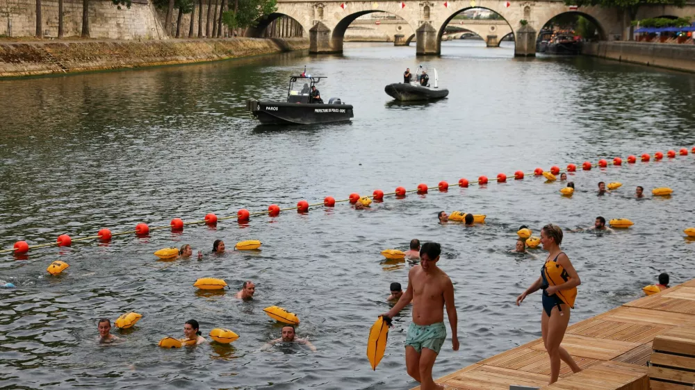 People swim in the River Seine at the Bras Marie site, opened to swimmers marking the first public bathing session in the capital's historic waterway, in Paris, France, July 5, 2025. REUTERS/Abdul Saboor