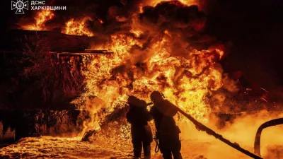 In this photo provided by the Ukrainian Emergency Service, emergency services personnel work to extinguish a fire following a Russian attack in Kharkiv region, Ukraine, Saturday, July 5, 2025. (Ukrainian Emergency Service via AP)