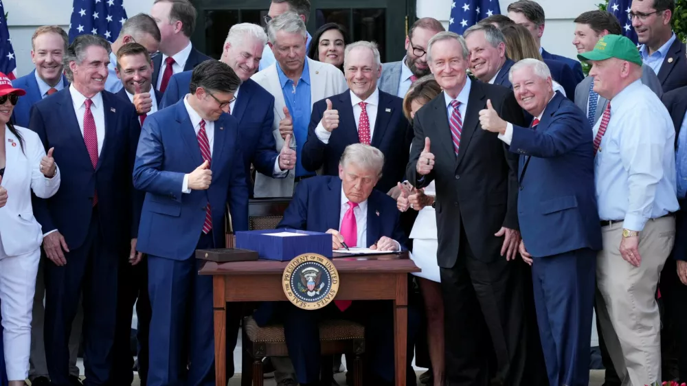 U.S. President Donald Trump signs a sweeping spending and tax legislation, known as the "One Big Beautiful Bill Act," during a picnic with military families to mark Independence Day, at the White House in Washington, D.C., U.S., July 4, 2025. REUTERS/Ken Cedeno