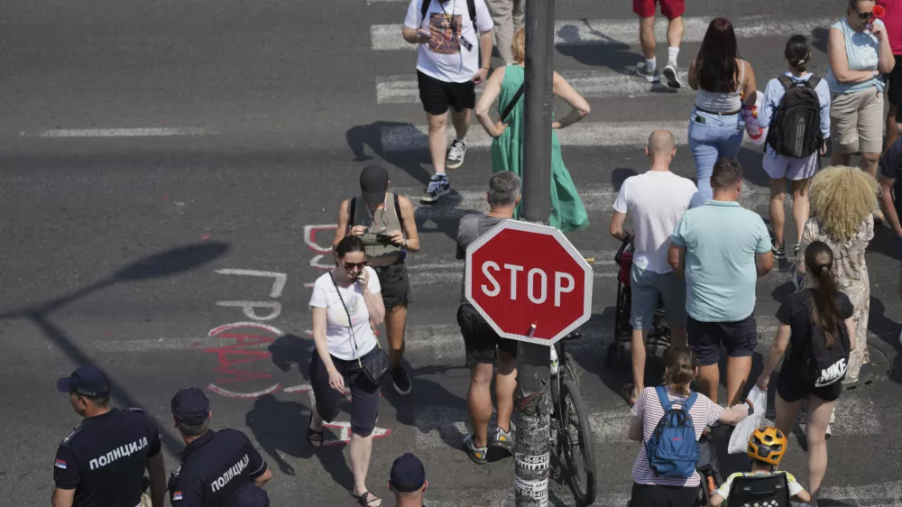 Serbian police officers guard an intersection after removing street blockades that were set up as part of a protest after a massive rally demanding an early parliamentary election in Belgrade, Serbia, Saturday, July 5, 2025. (AP Photo/Darko Vojinovic)