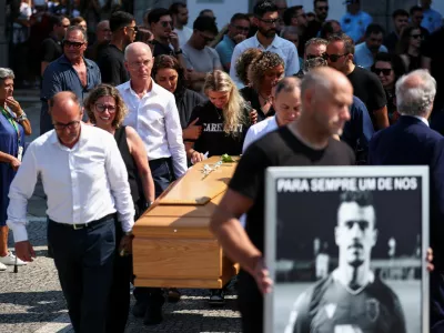 Maria Rodrigues reacts as pallbearers carry a coffin, at the funeral ceremony of her late husband Andre Silva, brother of Liverpool's Portuguese soccer player Diogo Jota, who both died in a car crash near Zamora, Spain, at the Chapel of the Resurrection, in Gondomar, Portugal, July 5, 2025. REUTERS/Pedro Nunes