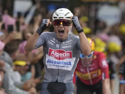 Belgium's Jasper Philipsen celebrates as he crosses the finish line to win the first stage of the Tour de France cycling race over 184.9 kilometers (114.9 miles) with start and finish in Lille, France, Saturday, July 5, 2025. (AP Photo/Thibault Camus)