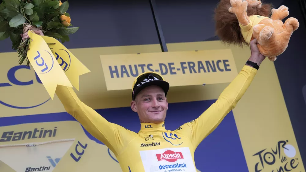 Netherlands' Mathieu van der Poel wearing the overall leader's yellow jersey celebrates on the podium after winning the second stage of the Tour de France cycling race over 209.1 kilometers (129.9 miles) with start in Lauwin-Planque and finish in Boulogne-sur-Mer, France, Sunday, July 6, 2025. (AP Photo/Mosa'ab Elshamy)