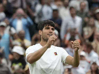 Spain's Carlos Alcaraz celebrates after beating Russia's Andrey Rublev during a fourth round men's singles match at the Wimbledon Tennis Championships in London, Sunday, July 6, 2025. (AP Photo/Alastair Grant)