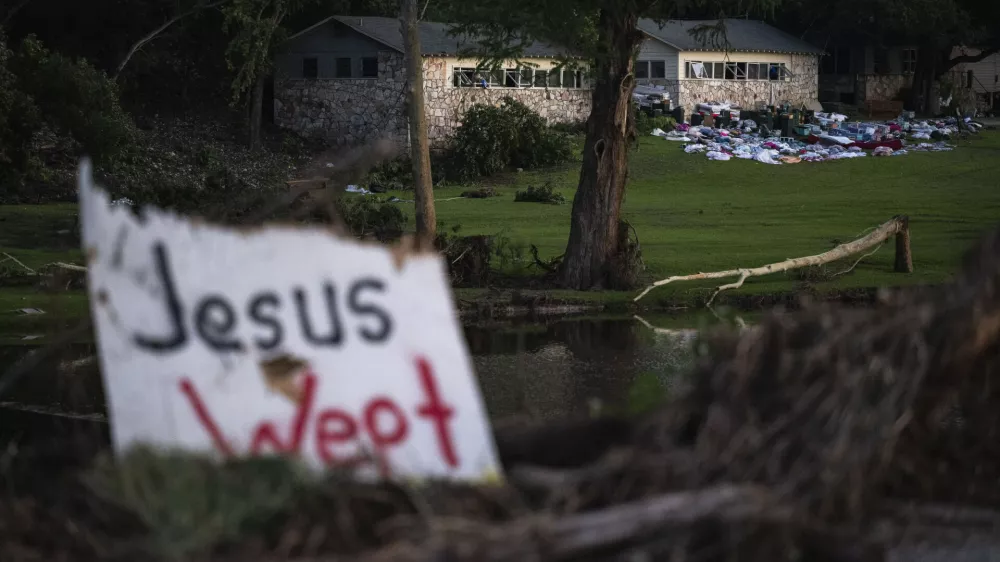 Camper's belongings sit outside one of Camp Mystic's cabins near the Guadalupe River, Monday, July 7, 2025, in Hunt, Texas, after a flash flood swept through the area. (AP Photo/Eli Hartman)