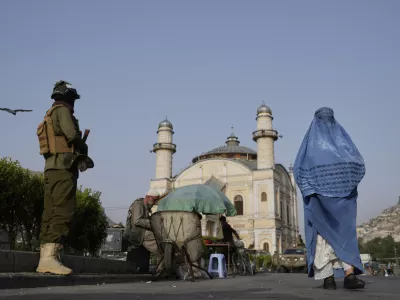 A Taliban fighter stands guard near the Shah-Do Shamshira Mosque as people attend the Eid al-Adha prayer in Kabul, Afghanistan, Saturday, June 7, 2025. (AP Photo/Ebrahim Noroozi)