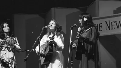 American singer, songwriter, musician and activist Joan Baez American singer-songwriter and activist Mimi Farina (1945 - 2001) and Judy Collins at Newport Folk Festival 15th July 1967. (Photo by John Byrne Cooke Estate/Getty Images)