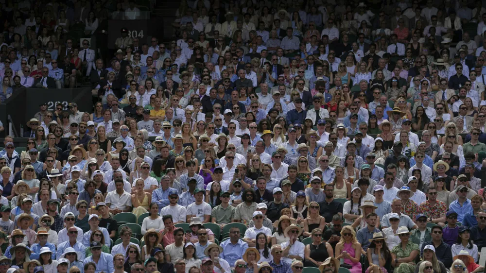 Spectators pack the stands of Centre Court as Switzerland's Belinda Bencic plays Mirra Andreeva of Russia during a quarterfinal women's singles match between at the Wimbledon Tennis Championships in London, Wednesday, July 9, 2025. (AP Photo/Kin Cheung)