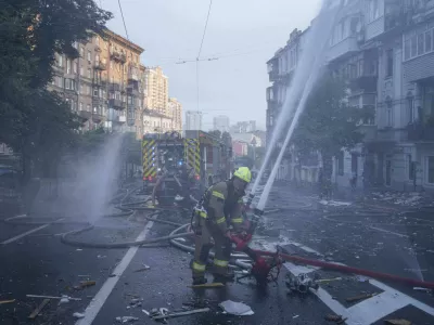 Rescue workers put out a fire of a residential house heavily damaged by a Russian strike in Kyiv, Ukraine, on Thursday, July 10, 2025. (AP Photo/Evgeniy Maloletka)