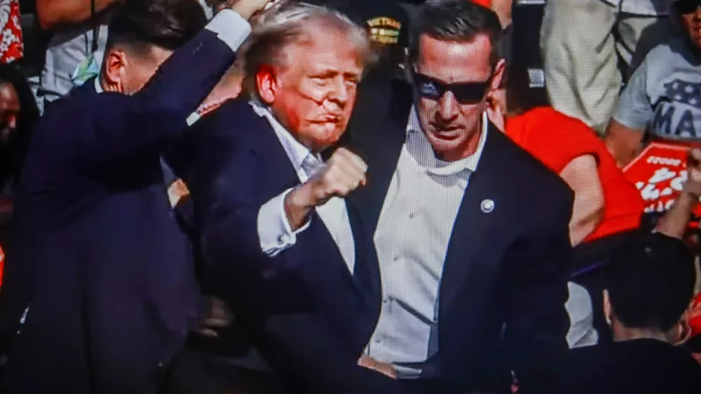 SCREENSHOT - 14 July 2024, US, Butler: Former US President Donald Trump is rushed off stage by secret service after being struck by gunfire during his Presidential Election campaign rally in Butler Pennsylvania. Photo: Artem Priakhin/SOPA Images via ZUMA Press Wire/dpa