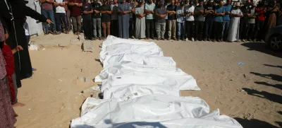 A woman reacts as mourners pray during the funeral of Palestinians killed overnight in Israeli attacks on tents, according to Gaza's health ministry, at Nasser Hospital in Khan Younis, southern Gaza Strip, July 9, 2025. REUTERS/Hatem Khaled