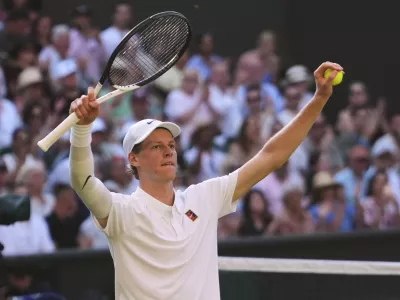 Jannik Sinner of Italy celebrates winning the men's semifinal singles match against Novak Djorkovic of Serbia at the Wimbledon Tennis Championships in London, Friday, July 11, 2025.(AP Photo/Kirsty Wigglesworth)
