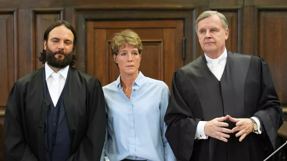 German entrepreneur and gastronome Christina Block and her lawyers Otmar Kury and Ingo Bott wait for the start of her trial at the regional court in Hamburg, Germany, July 11, 2025. Marcus Brandt/Pool via REUTERS