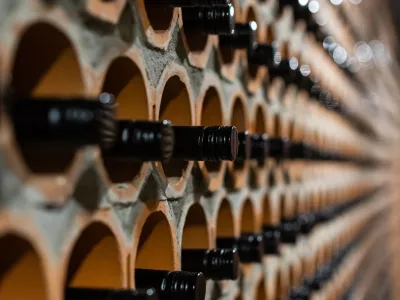Archive of red wine with black corks in the wine cellar in special brick openings. Bela Krajina, Slovenia