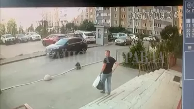 A CCTV footage shows a Security Service of Ukraine (SBU) officer walking down the stairs moments before he was shot in Kyiv, Ukraine July 10, 2025 in this screengrab obtained from a social media video. Ukrainska Pravda/via REUTERS THIS IMAGE HAS BEEN SUPPLIED BY A THIRD PARTY. MANDATORY CREDIT. UKRAINE OUT. NO COMMERCIAL OR EDITORIAL SALES IN UKRAINE. RUSSIA OUT. NO COMMERCIAL OR EDITORIAL SALES IN RUSSIA. WATERMARK FROM SOURCE. TPX IMAGES OF THE DAY VERIFICATION: - Guard box, buildings and parking lot layout matched file and satellite imagery - Date verified by timestamp and Reuters reporting