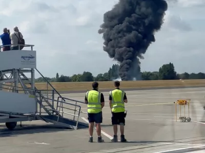 A plume of black smoke rises from an area near the runway after a small plane crash, as seen from inside a building at London Southend Airport, in Southend, Britain, July 13, 2025, in this screen grab obtained from a social media video. @agussromagnoli via X/via REUTERS THIS IMAGE HAS BEEN SUPPLIED BY A THIRD PARTY. MANDATORY CREDIT.