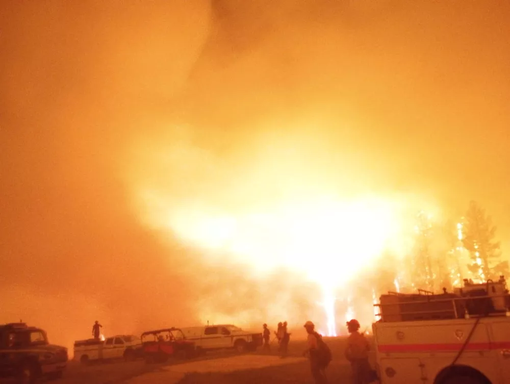 Firefighters and emergency vehicles are positioned in front of the Dragon Bravo Fire in Grand Canyon, Arizona, U.S. in this image released July 13, 2025.  National Park Service/Handout via REUTERS  THIS IMAGE HAS BEEN SUPPLIED BY A THIRD PARTY. MANDATORY CREDIT.