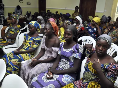 Chibok school girls recently freed from Boko Haram captivity are seen in Abuja, Nigeria, Sunday, May 7, 2017. The 82 freed Chibok schoolgirls arrived in Nigeria's capital on Sunday to meet President Muhammadu Buhari as anxious families awaited an official list of names and looked forward to reuniting three years after the mass abduction. (AP Photo/ Olamikan Gbemiga)