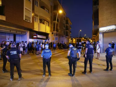 Local police officers and Spanish civil guard agents take positions during the disturbances in Torre Pacheco, eastern Spain, Friday, July 12, 2025. (Mart&iacute;n C./Europa Press via AP)