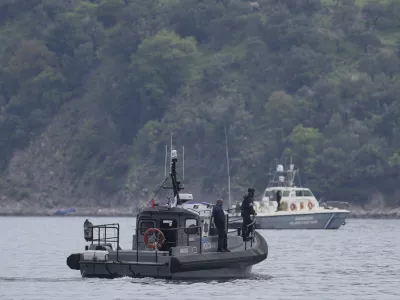 FILE- Frontex, foreground, and Greek coast guard vessels take part in a search and rescue operation, after the capsizing of a boat carrying migrants, off the coast on the northeastern Aegean Sea island of Lesbos, Greece, on April 3, 2025. (AP Photo/Panagiotis Balaskas, File)