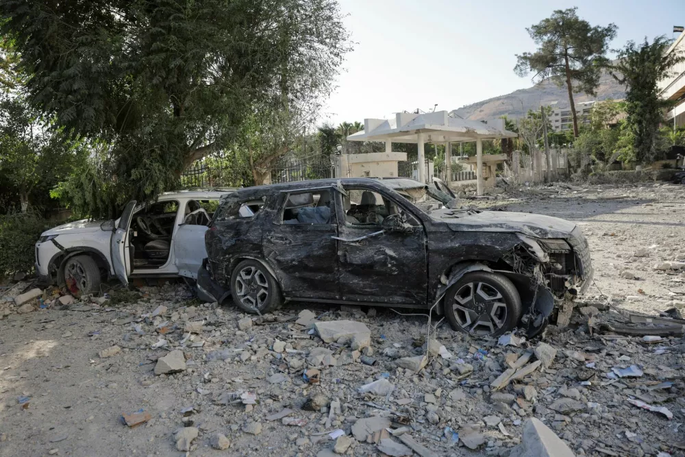 Destroyed cars sit in the street, after powerful airstrikes shook Damascus on Wednesday, targeting the defense ministry, as Israel vowed to destroy Syrian government forces attacking Druze communities in southern Syria and demanded their withdrawal, in Damascus July 16, 2025. REUTERS/Khalil Ashawi