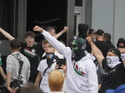 Supporters of Polish far-right Confederation party and soccer hooligans take part in a anti-immigration demonstration in Warsaw Saturday, July 19, 2025. (AP Photo/Czarek Sokolowski)