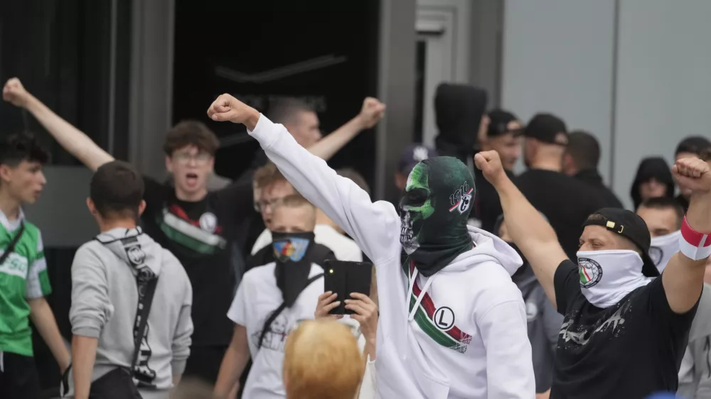 Supporters of Polish far-right Confederation party and soccer hooligans take part in a anti-immigration demonstration in Warsaw Saturday, July 19, 2025. (AP Photo/Czarek Sokolowski)