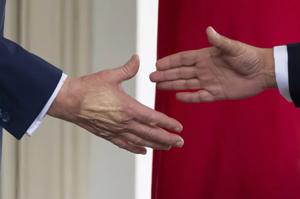 FILE - President Donald Trump, left, reaches to shake hands with Bahrain's Crown Prince Salman bin Hamad Al Khalifa speak upon his arrival at the White House, July 16, 2025, in Washington. (AP Photo/Alex Brandon, File)