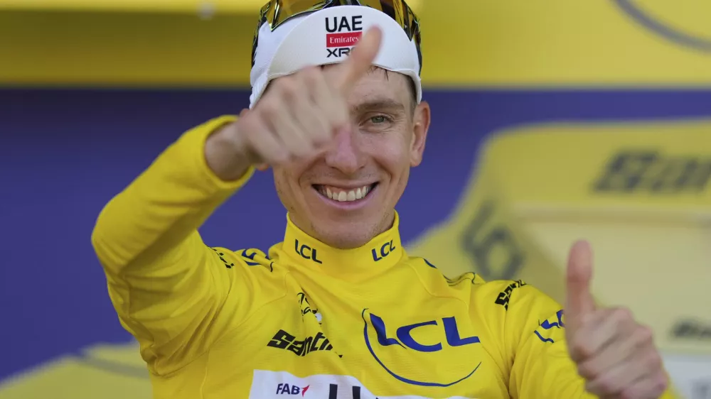 Stage winner Slovenia's Tadej Pogacar celebrates taking the yellow jersey after the twelfth stage of the Tour de France cycling race over 180.6 kilometers (112.2 miles) with start in Auch and finish in Hautacam, France, Thursday, July 17, 2025. (AP Photo/Mosa'ab Elshamy)