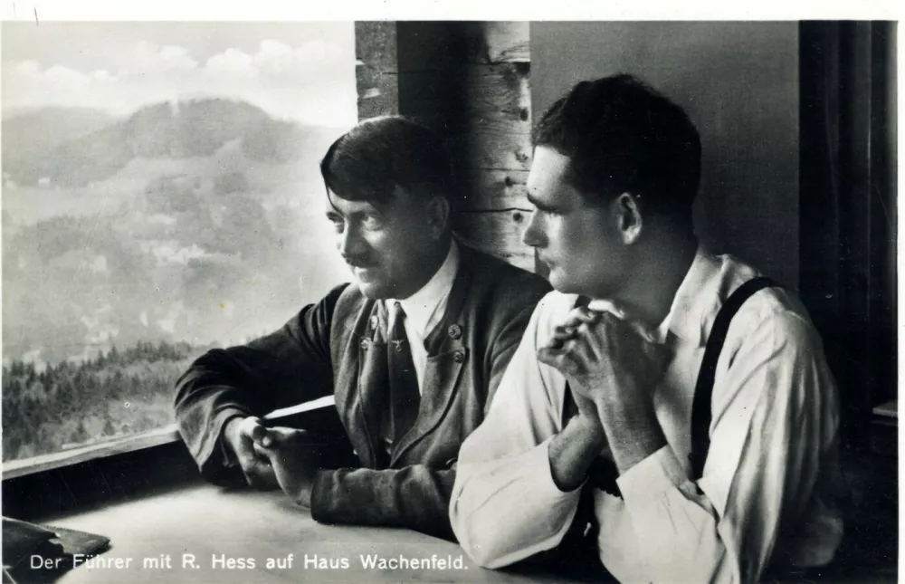 Coincidentally, Hess served in the same infantry regiment, the 6th Bavarian Reserve Division, as Adolf Hitler during the First World War, although he later qualified as a pilot. After the Armistice he joined the right-wing Freikorps and took part in street battles against the Communists. An early member of the Nazi Party, he became very close to Hitler and voluntarily joined him in prison after the failure of the Munich putsch. There, and later, he helped Hitler in the writing of Mein Kampf. They are seen here in the Berghof (Haus Wachenfeld) overlooking the Unterberg.  Date: circa 1920s,Image: 796679967, License: Rights-managed, Restrictions:, Model Release: no