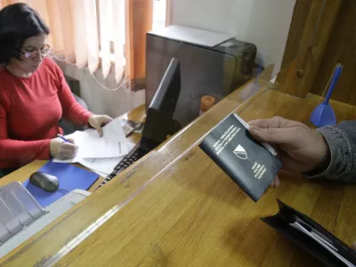 Bosnian citizen submit applications and old passport for issuing new biometric passport at police station in Sarajevo,Bosnia, on Monday, Nov. 8, 2010. European Union nations decided unanimously Monday to end visa requirements for residents of Bosnia and Albania by mid-December.The move by the EU Interior Ministers came despite fears that it will increase the number of unfounded asylum requests in the EU from the two nations. (AP Photo/Amel Emric)