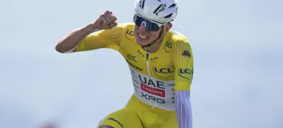 Slovenia's Tadej Pogacar, wearing the overall leader's yellow jersey, celebrates winning the thirteenth stage of the Tour de France cycling race, an individual time-trial over 10.5 kilometers (6.5 miles) in the Pyrenees mountains with start in Loudenvielle and finish in Peyragudes, France, Friday, July 18, 2025. (AP Photo/Thibault Camus)