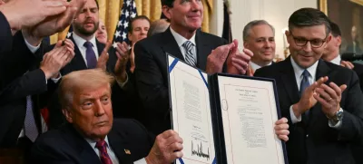 U.S. President Donald Trump holds the signed "Genius Act", which will develop regulatory framework for stablecoin cryptocurrencies and expand oversight of the industry, at the White House in Washington, D.C., U.S., July 18, 2025. REUTERS/Annabelle Gordon
