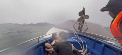 This image from a video provided by QDND shows people on a rescue boat after their tourist boat capsized in Ha Long Bay, Vietnam on Saturday, July 19, 2025. (QDND via AP)