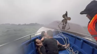 This image from a video provided by QDND shows people on a rescue boat after their tourist boat capsized in Ha Long Bay, Vietnam on Saturday, July 19, 2025. (QDND via AP)