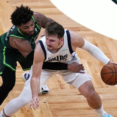 Dallas Mavericks guard Luka Doncic, right, is pressured by Boston Celtics guard Marcus Smart during the second half of an NBA basketball game Wednesday, March 31, 2021, in Boston. (AP Photo/Charles Krupa)