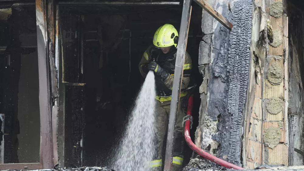 Firefighters work in a destroyed apartment building after a Russian attack in Kyiv, Ukraine, Monday, July 21, 2025. (AP Photo/Efrem Lukatsky)