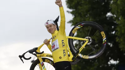 Cycling - Tour de France - Stage 21 - Mantes-la-Ville to Paris - Paris, France - July 27, 2025 UAE Team Emirates XRG's Tadej Pogacar celebrates on the podium with his bike while wearing the yellow jersey after winning the Tour de France REUTERS/Benoit Tessier