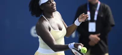 Venus Williams hits a ball toward the crowd after a doubles match with Hailey Baptiste against Eugenie Bouchard and Clervie Ngounoue at the Citi Open tennis tournament Monday, July 21, 2025, in Washington. (AP Photo/Nick Wass)