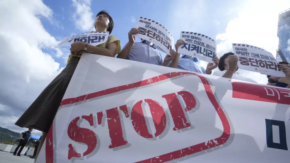 Members of civic groups protest against U.S. President Donald Trump's tariffs policy on South Korea, near the U.S. embassy in Seoul, South Korea, Tuesday, July 22, 2025. The banners reads " The U.S. should stop raising unfair tariffs and pressuring for increased military spending."(AP Photo/Ahn Young-joon)