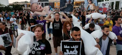 Demonstrators carry sacks of flour, during a protest demanding an end to the war in Gaza and the release of all hostages, in Tel Aviv, Israel, July 22, 2025. REUTERS/Ammar Awad