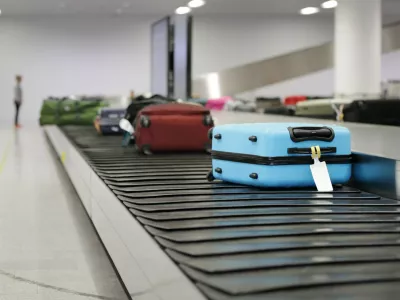 Suitcase or luggage on conveyor belt in the airport waiting
