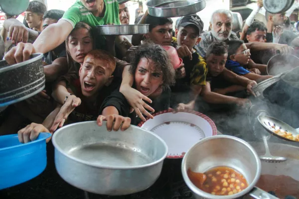 FILE PHOTO: Palestinians gather to receive food cooked by a charity kitchen, amid the Israel-Hamas conflict, in the northern Gaza Strip, September 11, 2024. REUTERS/Mahmoud Issa/File Photo