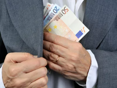 man putting money in his pocket