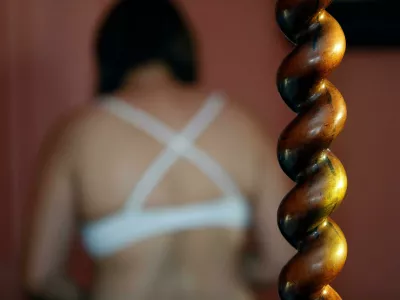 2KG2WTW Back of a woman wearing a bra. Victim waiting for help. Sexual violence concept.