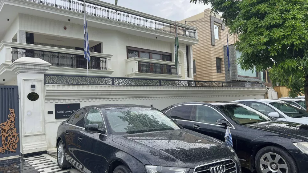 Luxury cars cars bearing fake diplomatic number plates are parked outside a rented residential building in which a bogus embassy was running in Ghaziabad, outskirts of New Delhi, India, Monday, July 21, 2025. (Uttar Pradesh Police Special Task Force via AP)