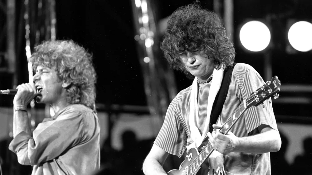 FILE - In this July 13, 1985 file photo, singer Robert Plant, left, and guitarist Jimmy Page of the British rock band Led Zeppelin perform at the Live Aid concert at Philadelphia's J.F.K. Stadium. Generations of aspiring guitarists have tried to copy the riff from Led Zeppelin's &acirc;&euro;śStairway to Heaven.&acirc;&euro;ť Starting Tuesday, June 14, 2016, a Los Angeles court will try to decide whether the members of Led Zeppelin themselves ripped off that riff. Page and Plant are named as defendants in the lawsuit brought by the trustee of late guitarist Randy Wolfe from the band Spirit. (AP Photo/Rusty Kennedy, File)